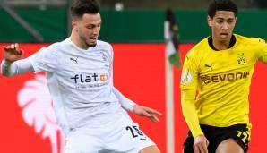 Gladbachs Ramy Bensebaini (l.) im Duell mit Jude Bellingham von Borussia Dortmund.