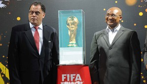 Danny Jordaan (l.) präsentiert den WM-Pokal